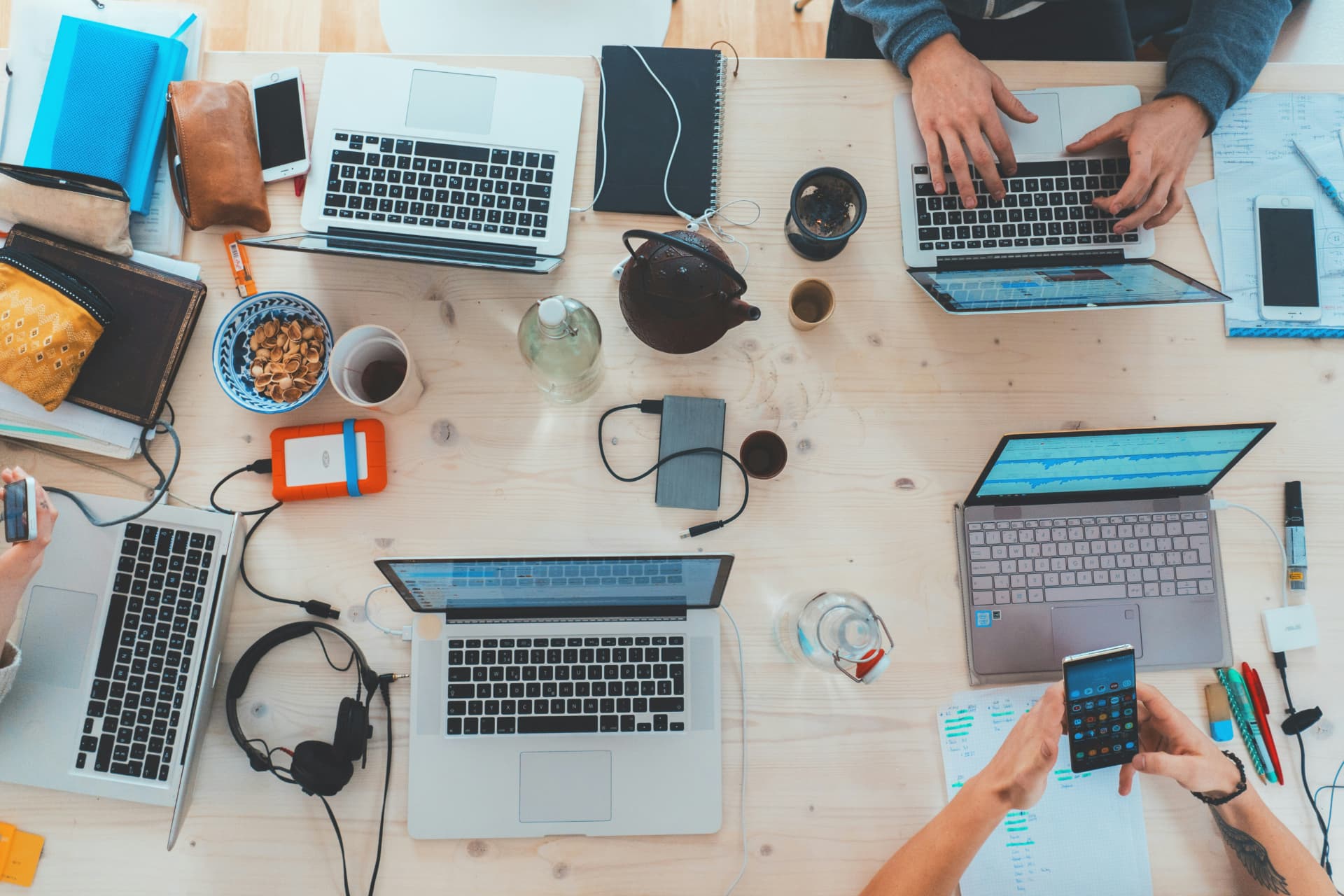 A product team working together across laptops and notes